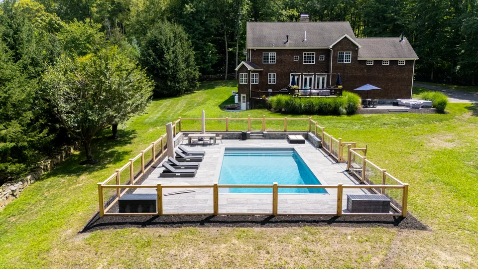 Aerial view of a cedar-post and black-wire fence enclosing a pool and its bluestone deck — Exterior Services LLC, Redding, CT